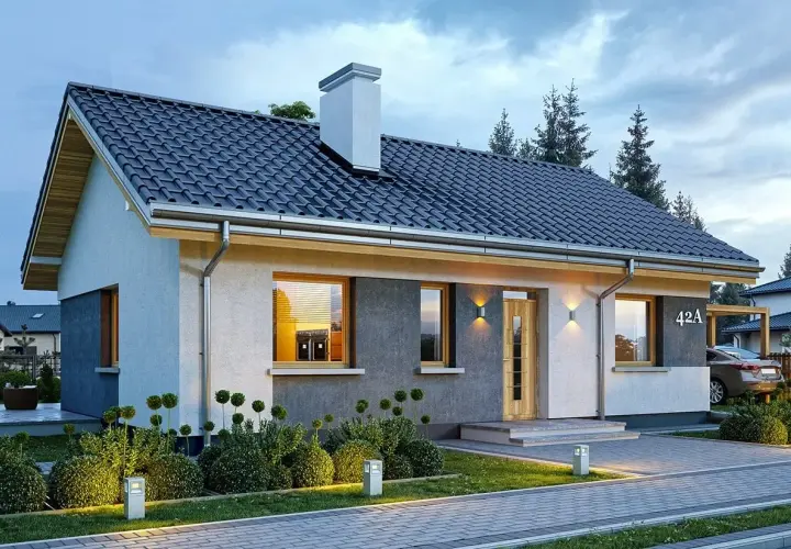 Nowoczesny dom parterowy, projekt domu Kasia 2, z oświetlonym ogrodem i podjazdem.