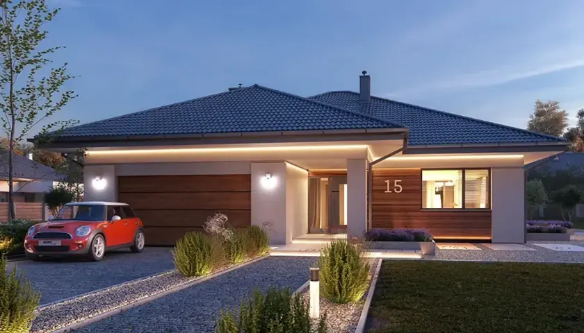 Nowoczesny ariel projekt domu z garażem, oświetlony wieczorem. Obok czerwony mini cooper.