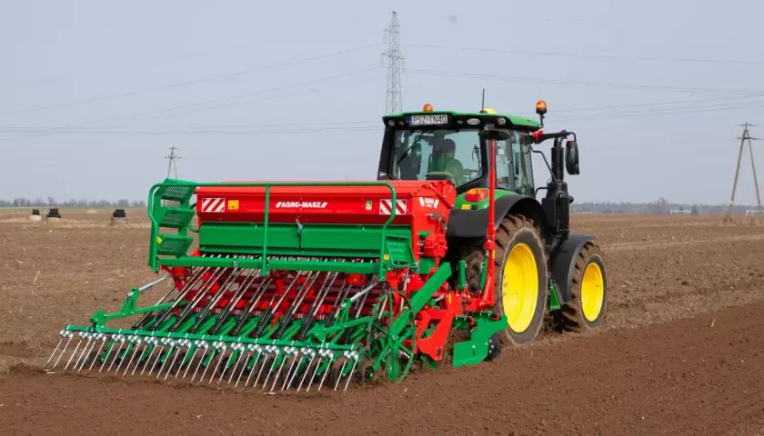 Traktor z siewnikiem Agro-Masz przygotowuje pole pod nasiona rzepaku na 1 ha.