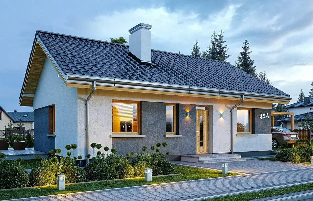 Nowoczesny dom parterowy, projekt domu Kasia 2, z oświetlonym ogrodem i podjazdem.