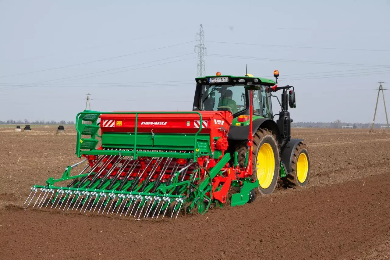 Traktor z siewnikiem Agro-Masz przygotowuje pole pod nasiona rzepaku na 1 ha.